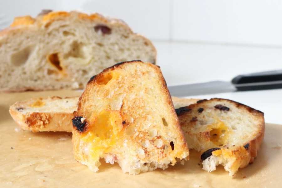 toasted slice of cheesy Ciabatta loaf pulled in half - BREADISTA