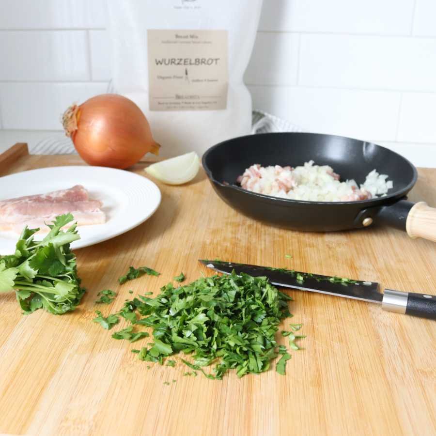 prep-work with chopping bacon, onions and parsley for a hearty rustic baguette - BREADISTA