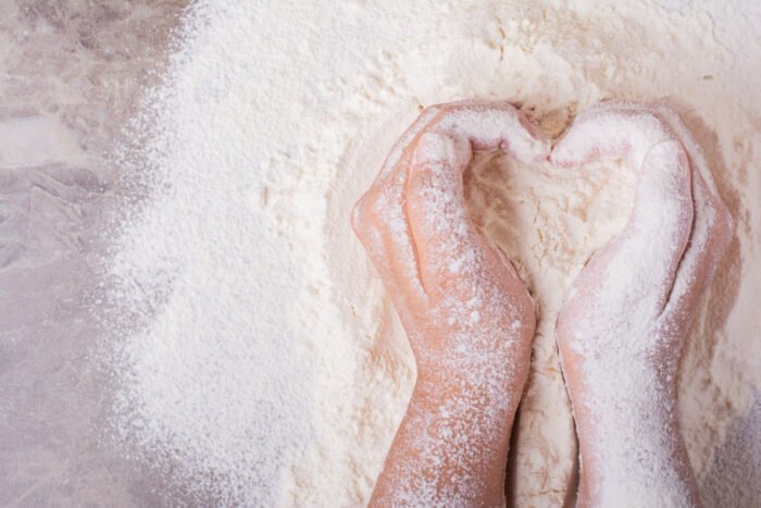 two hands shaped as hard in flour