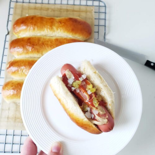 served Hot Dog in soft bun on white plate. Made with Artisan Bread Mix - Einback.