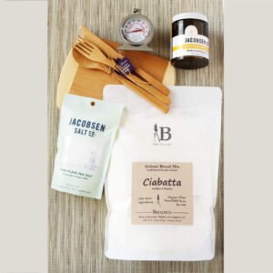 Birdview of Sweet n' Salty Gift Box for Bread Baker with bamboo cutting board and utensils, jar of honey, oven thermometer, pouch of sea salt, bread mix