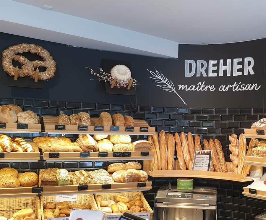 bread shelves with loaves, baguettes, rolls of the German bread culture - courtesy of artisan bakery Dreher in the City Kehl