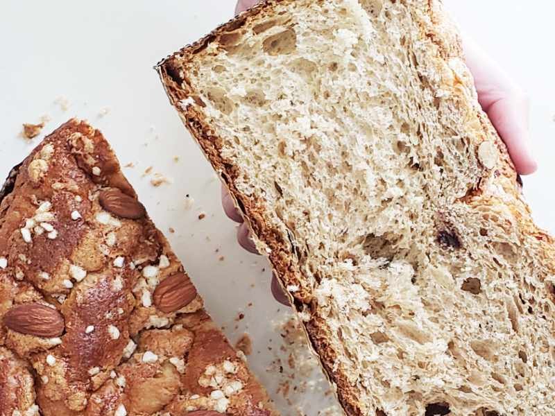 Close-up crumbshot - hand holds half of homemade Italian Easter Bread Colomba