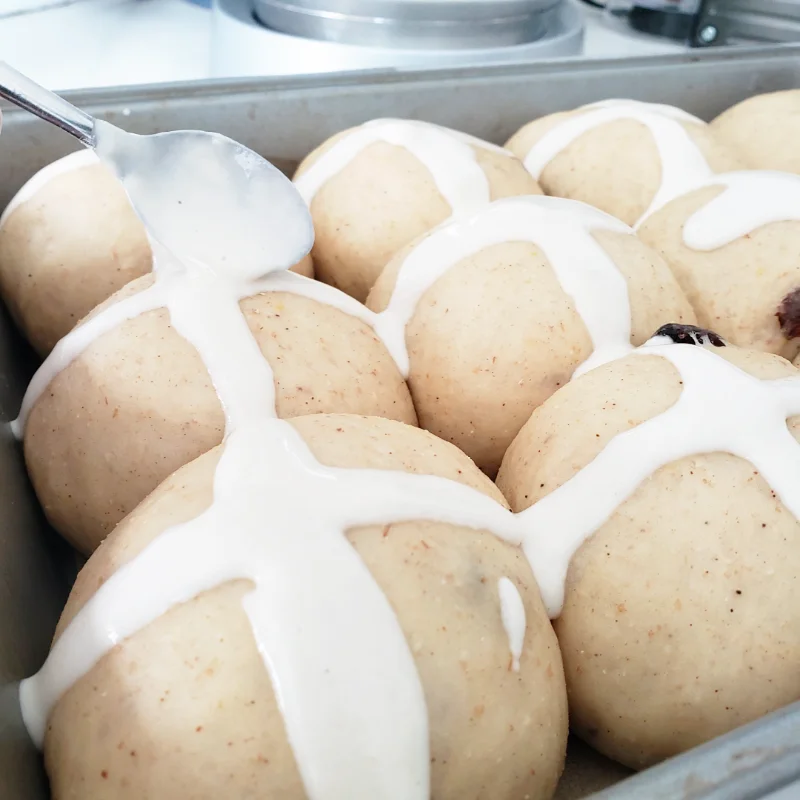 Close-up - proofen dough balls with flour-water mix cross - Hot Cross Buns