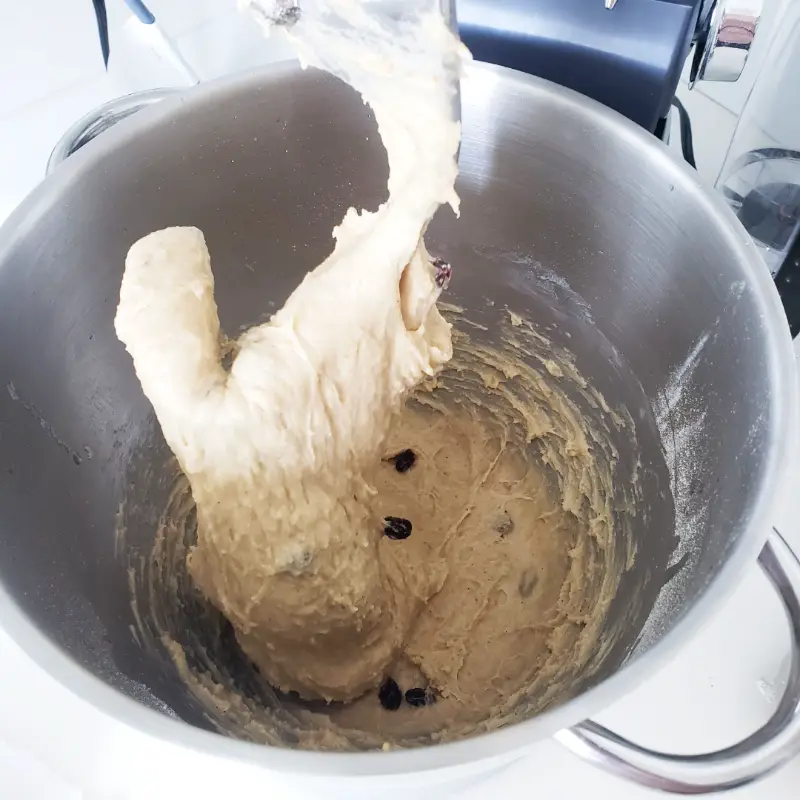 sticky dough in bowl of stand mixer with dough hook up