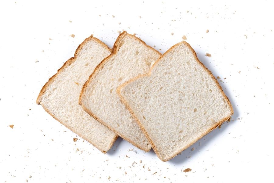 three slices of white sandwich bread overlapping each other