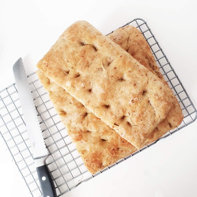 Baked easiest Focaccia - halves stacked on rack - Birdview by BREADISTA