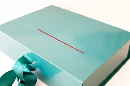 green gift box with green ribbon
