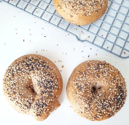 2 Bagels in 2 different Shaping Versions on white counter top - Eyelet and poked by BREADISTA - instructions for bagel bread mix
