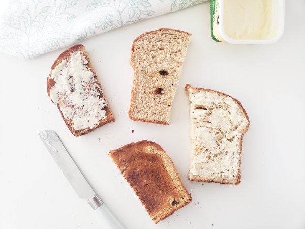 4 Half slices of Cinnamon Raisin Loaf showing options: toasted, untoasted, with and without Butter by BREADISTA