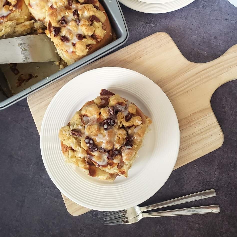 Giant Cinnamon Roll with Streusel topping on white plate - baked - birdview by BREADISTA