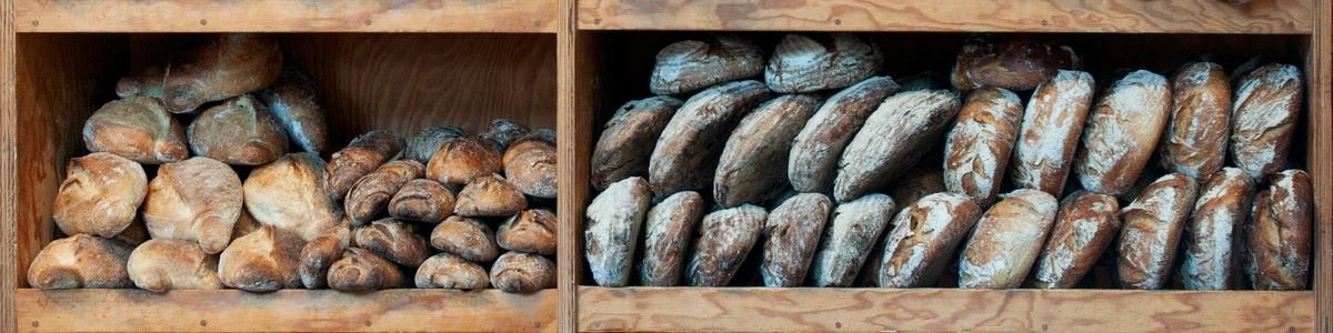 rustic artisan breads stacked on wooden shelf